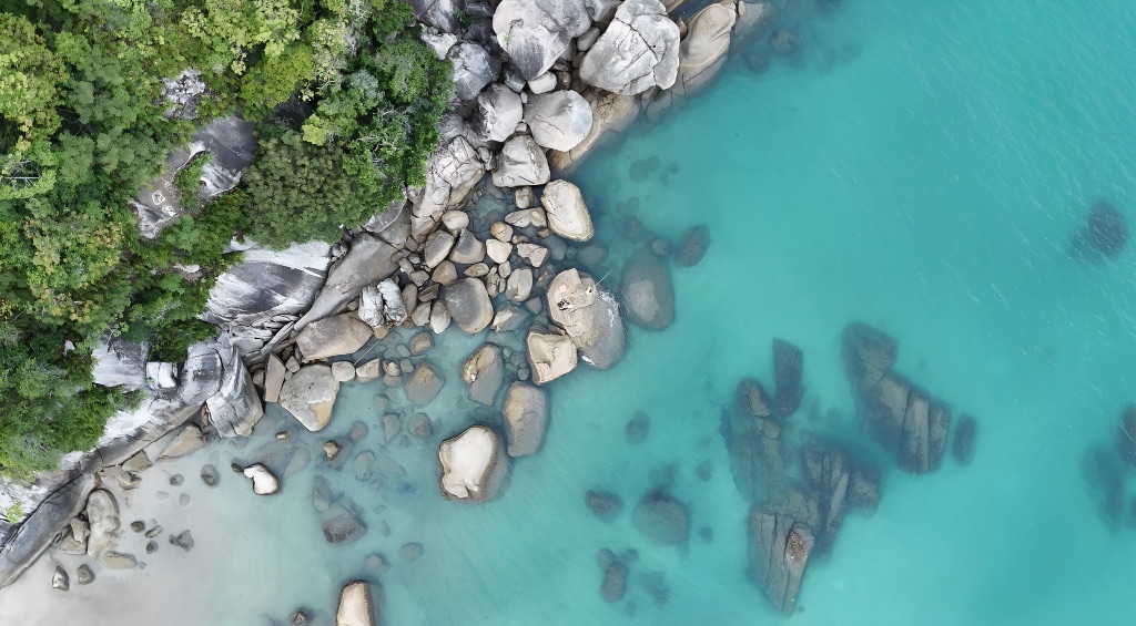 Turquoise water and granite boulders from above