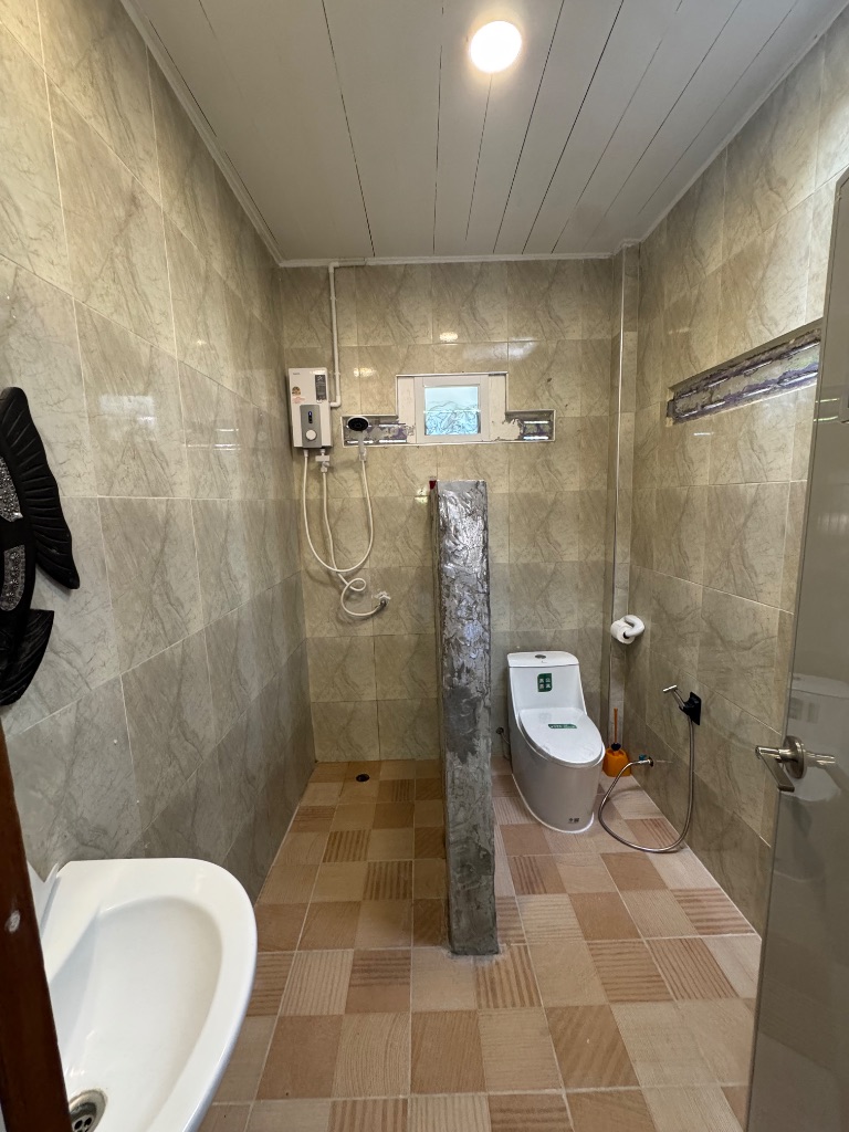 Tiled bathroom with hot shower