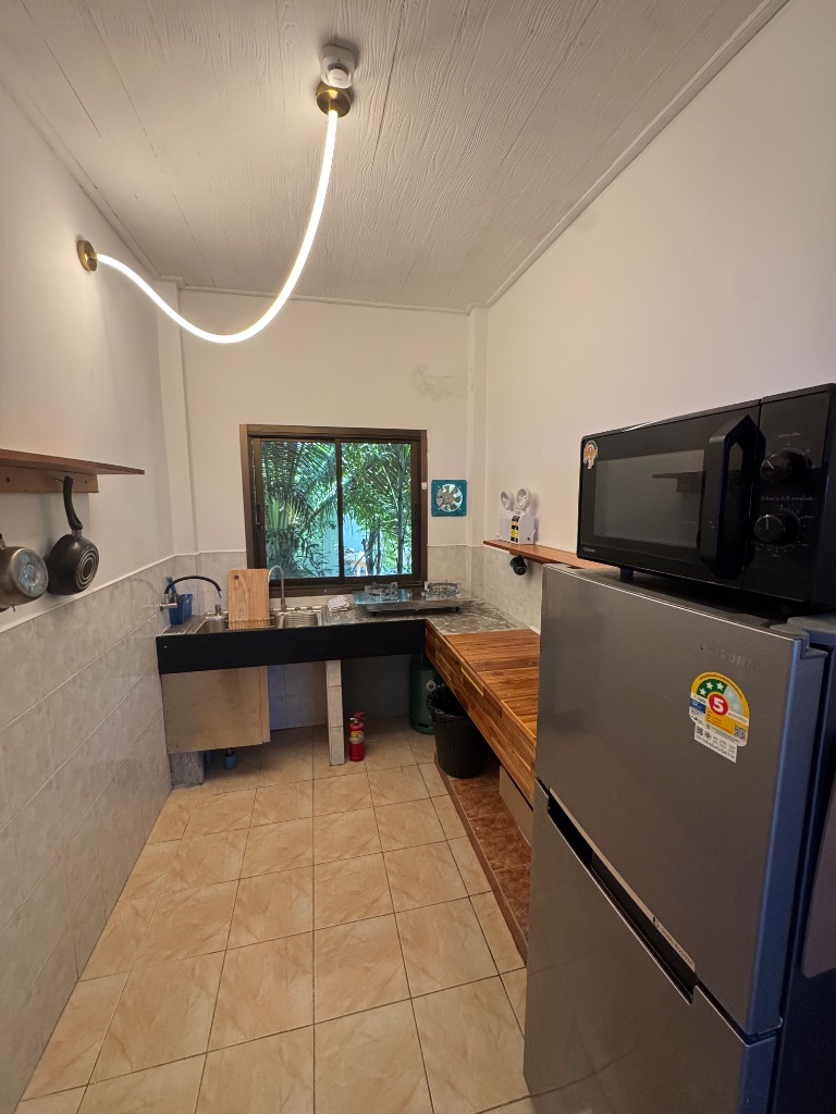 Kitchen with fridge and microwave