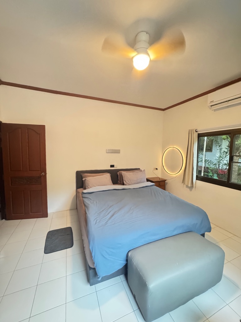 The Villa — large bedroom with AC and ceiling fan